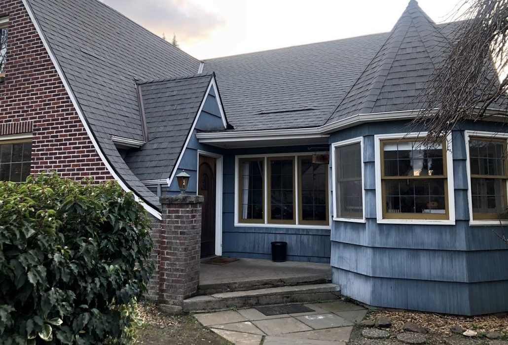The same house after painting, with blue siding and white trim